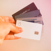 A hand holding a fanned out set of credit cards